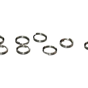 May include: A set of eight silver key rings. The key rings are all the same size and shape, and they are made of a durable metal.