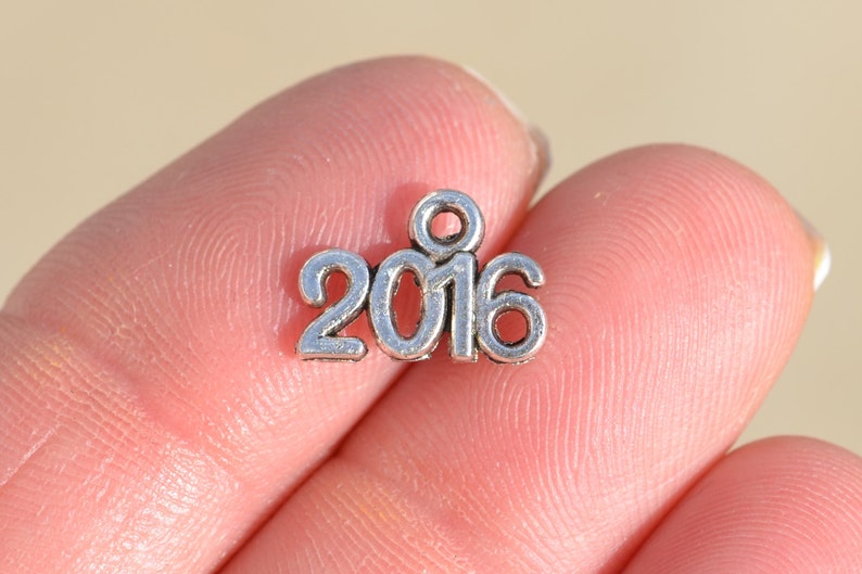 BULK 50 Year 2016 Silver Tone Charms SC2402