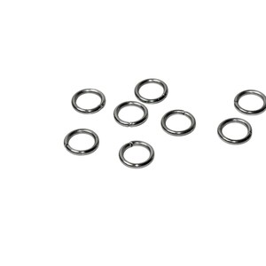 May include: A collection of seven small, circular metal jump rings with a smooth, polished silver-tone finish. Each ring features a single, thin cut along its circumference, allowing the ring to be opened and closed for connecting jewelry components.