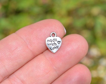 May include: Silver heart-shaped charm with the words "Made with Love" engraved on it.