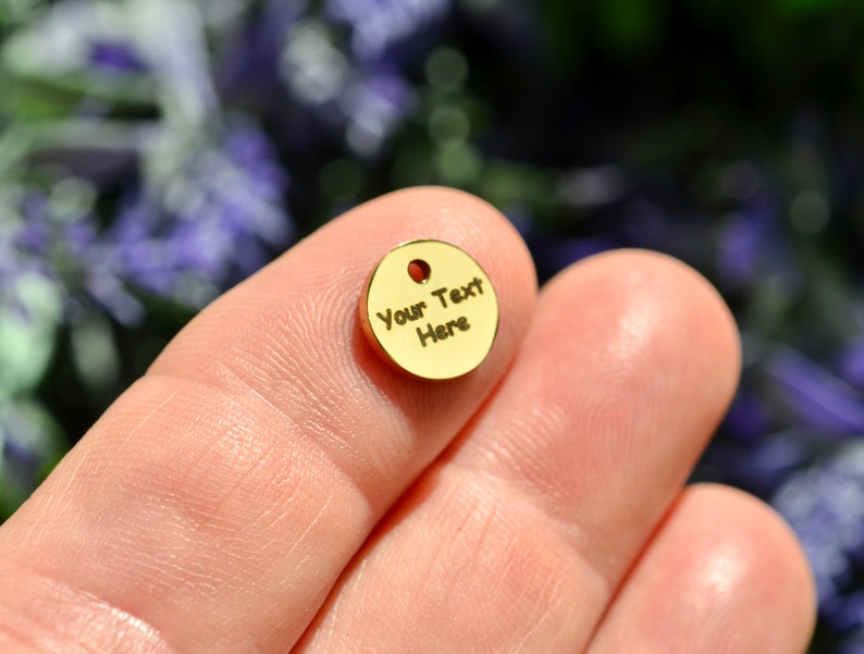 Op de afbeelding: Een gouden metalen schijf met de tekst "Your Text Here" erop gegraveerd.