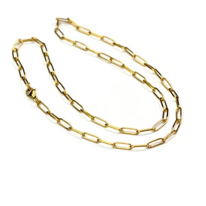 May include: A gold chain necklace with a simple, linked design. The chain is made of small, oval-shaped links.