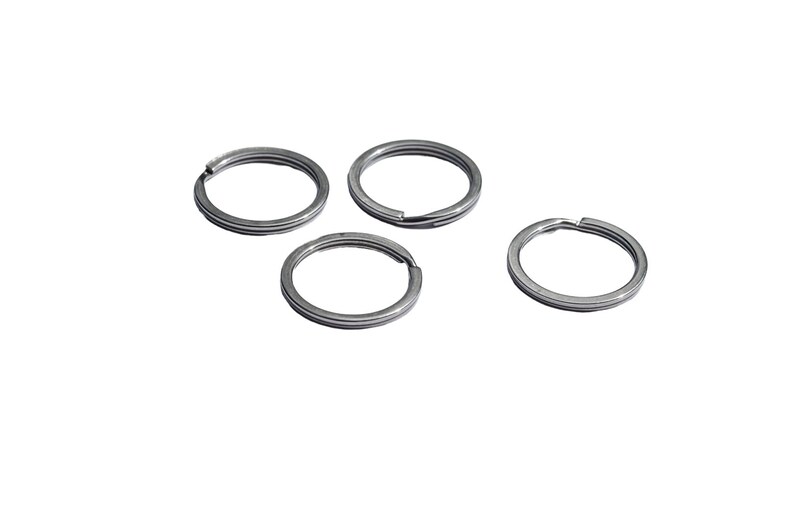 May include: Four silver key rings, each with a circular shape and a smooth, metallic finish.