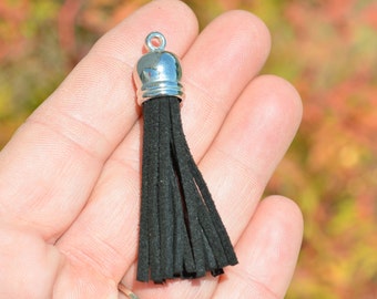 May include: A black suede tassel with a silver metal top. The tassel is about 2 inches long.