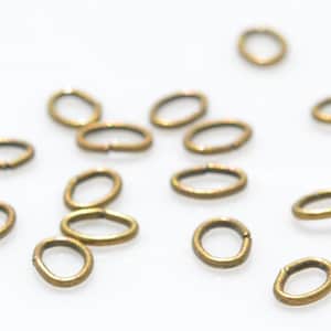 100 Bronze Tone 5mm Oval Jump Rings  F427
