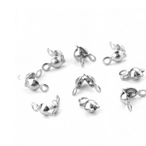 May include: Silver-toned metal clasps for jewelry making. The clasps have a round shape with a small loop on each side. The clasps are designed to be used for necklaces, bracelets, and other jewelry projects.