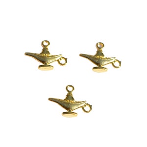 May include: Three gold-coloured metal genie lamp charms with a loop for hanging.