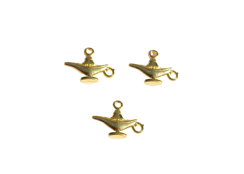 May include: Three gold-coloured metal genie lamp charms with a loop for hanging.