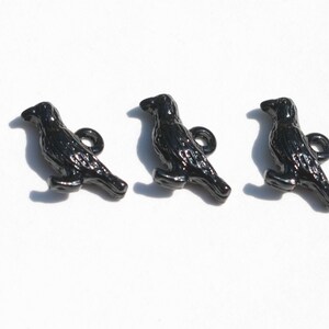 May include: Three black metal crow buttons with a loop on the back for sewing or attaching to a project.