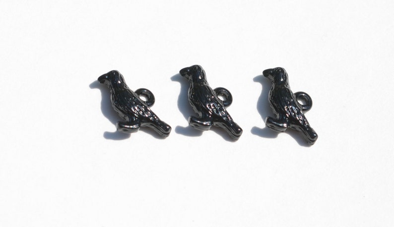 May include: Three black metal crow buttons with a loop on the back for sewing or attaching to a project.
