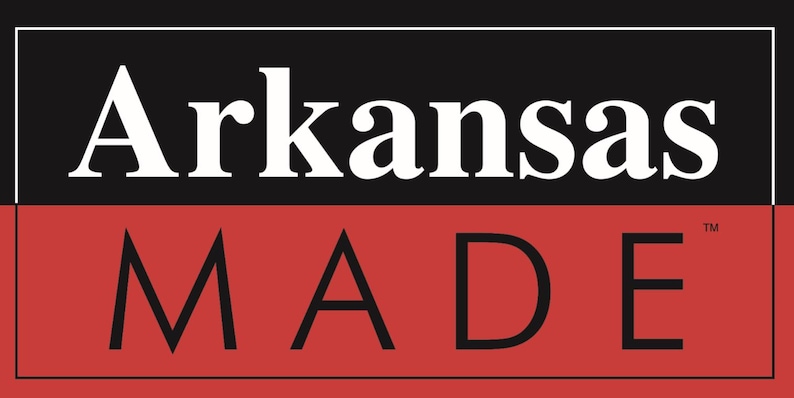 May include: A black and red logo with the text "Arkansas MADE" in white. The word "Arkansas" is in a larger font and is on a black background. The word "MADE" is in a smaller font and is on a red background.