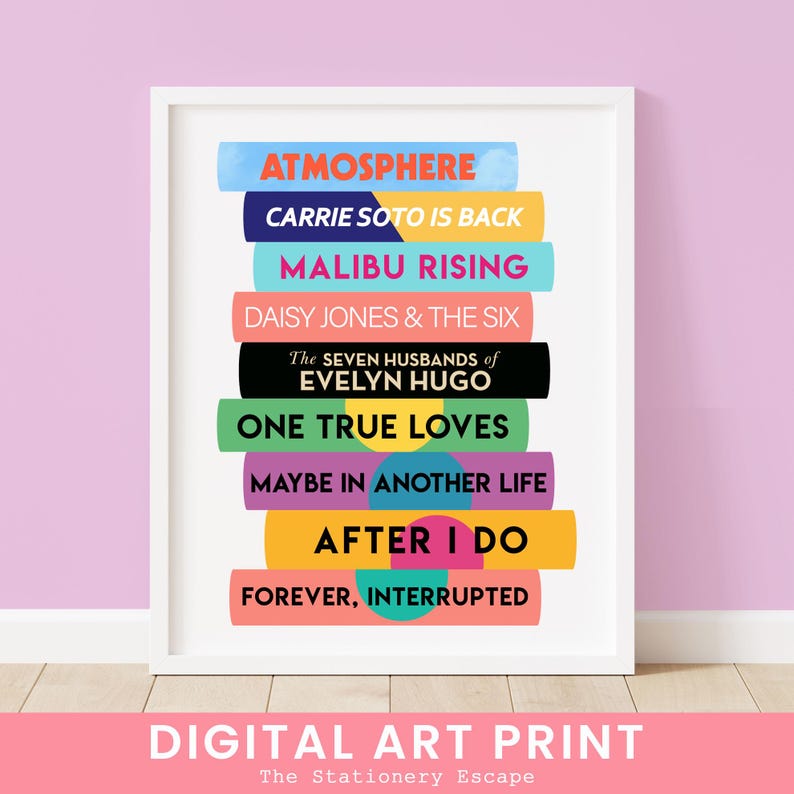 May include: A framed digital art print featuring a stack of colorful book spines. The titles include "Atmosphere," "Carrie Soto Is Back," "Malibu Rising," and "Daisy Jones & The Six." The print also includes the text "Digital Art Print."