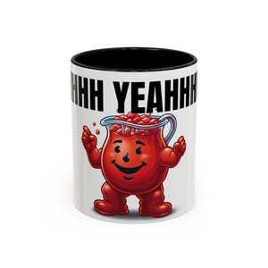 May include: A white ceramic mug with a black interior and the phrase "HH YEAHH" printed in black. The mug features a cartoon image of a red pitcher character with a smiling face and outstretched arms, filled with red berries.