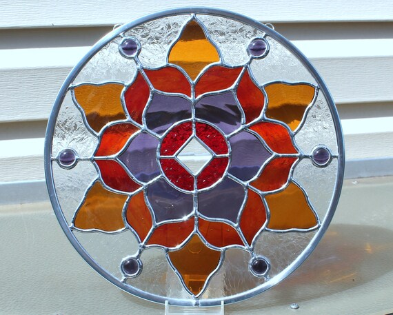 Surrounding the center clear glass bevel is textured red stained glass. 