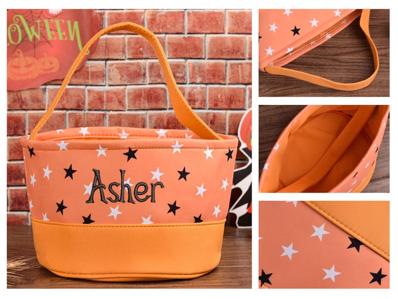 May include: Orange Halloween trick-or-treat bag with white and black star pattern. The bag has a matching orange handle and base. The name "Asher" is embroidered in black on the front. A Halloween sign is visible in the background.