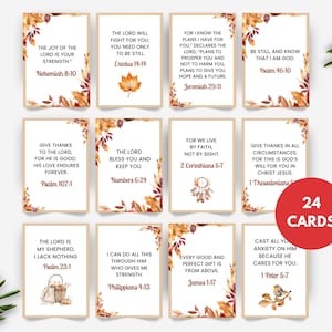 May include: A set of 24 cards with inspirational Bible verses. Each card features a different quote in black text, framed by a border of autumn leaves in shades of orange, brown, and yellow. A red circle indicates the number of cards.