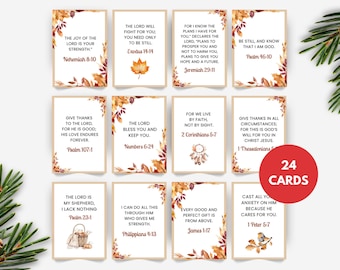 May include: A set of 24 cards with inspirational Bible verses. Each card features a different quote in black text, framed by a border of autumn leaves in shades of orange, brown, and yellow. A red circle indicates the number of cards.