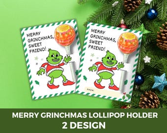 Puede incluir: Dos portachupetes con una ilustración del personaje de Grinch, cada uno sosteniendo una piruleta. Las tarjetas dicen "MERRY GRINCHMAS, SWEET FRIEND!" y están decoradas con un borde verde y blanco. El texto inferior dice "MERRY GRINCHMAS LOLLIPOP HOLDER 2 DESIGN."