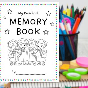 May include: A white preschool memory book with the text "My Preschool Memory Book" and a line for "By:". The cover features a black and white illustration of four children in graduation gowns. The book is surrounded by a colorful dotted border.