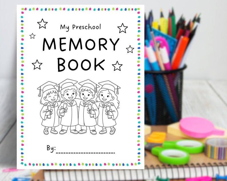 May include: A white preschool memory book with the text "My Preschool Memory Book" and a line for "By:". The cover features a black and white illustration of four children in graduation gowns. The book is surrounded by a colorful dotted border.