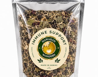 May include: A silver stand-up pouch containing a dried herbal blend. The label features a circular green and gold logo with the text "IMMUNE SUPPORT," "HAWAIIAN WONDERS," "HERBAL BLEND," and "MADE IN HAWAII," along with the weight "1 oz (28 gm)."