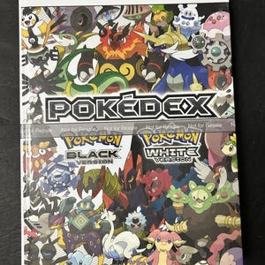 May include: The Official Unova Pokédex & Guide: Volume 2 book cover features a colorful collage of various Pokémon characters. The title POKÉDEX is centered, with Pokémon Black Version and Pokémon White Version logos displayed below the main graphic.
