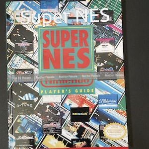 May include: A colorful Super NES Player's Guide book cover with a collage of game screenshots and logos, including Sim City, R-Type, Pilotwings, and Home Alone. The cover features the text "Super NES" in large, bold letters and "Player's Guide" in smaller letters.