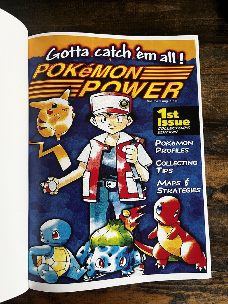 May include: A vintage Pok&eacute;mon Power magazine cover. The cover features the text "Gotta catch 'em all!" and "Pok&eacute;mon Power." The cover art includes the main character and several Pok&eacute;mon characters, including Pikachu, Squirtle, Bulbasaur, and Charmander. The magazine is a 1st Issue Collector's Edition.
