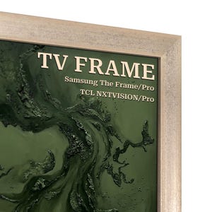 May include: A light-colored, textured wooden TV frame surrounding a screen displaying a dark green, abstract, swirling liquid paint design. The text TV FRAME, Samsung The Frame/Pro, and TCL NXTVISION/Pro are printed in white on the screen.