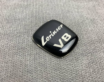 May include: Black Lorinser emblem with white lettering and a white "V8" logo.