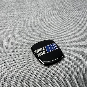 May include: A white ceramic mug with a black handle and the text "But First, Coffee" in a black, bold font. The mug is on a white surface.