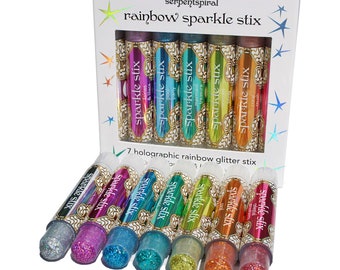 May include: A box set of seven holographic rainbow glitter sticks. Each stick is a different color, including silver, purple, blue, green, orange, and red. The box reads "rainbow sparkle stix" and "7 holographic rainbow glitter stix."