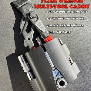 May include: A black multi-tool caddy holding a Milwaukee 5-inch plier wrench, a 711L mini ratchet, and bits. Text reads: MILWAUKEE 5INCH PLIER WRENCH MULTI-TOOL CADDY, CURVED BODY TO FIT POCKETS, 1/4 ONE SIDED BIT STORAGE, 711L MINI RATCHET HOLDER, BUILT IN WHISTLE.