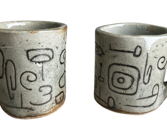 Pair of Hand-formed Mugs with Branding Iron Designs Angular Handles Beige