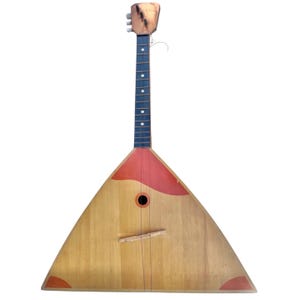 May include: A vintage balalaika, a Russian folk stringed instrument, with a triangular wooden body and a long neck. The body is light brown with red accents. The neck is dark with white dot inlays. The headstock is a lighter brown.