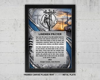 May include: A framed wall art piece featuring a metallic silver plaque with the text LINEMEN PRAYER. The background displays a graphic of a utility worker on a pole, power lines, and a sunset. The plaque includes a prayer and the name Gregor Lovato.