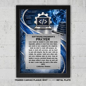 May include: A framed wall art piece featuring a silver metal plate with the text Software Engineer's Prayer by Catherine Thomas. The background displays blue digital circuit patterns, a laptop icon with code, and a stack of books labeled code.