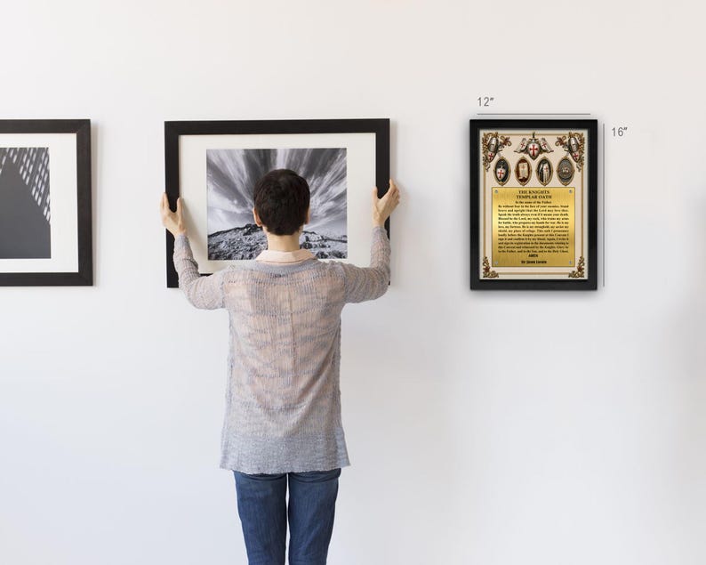 Peut inclure: Une plaque encadr&eacute;e du serment des Templiers mesurant 30,48 cm sur 40,64 cm. La plaque pr&eacute;sente une plaque m&eacute;tallique dor&eacute;e avec du texte noir, des accents d&eacute;coratifs aux coins et quatre embl&egrave;mes circulaires en haut, le tout dans un cadre noir.