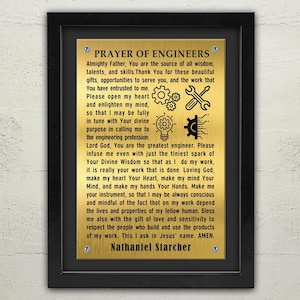 May include: A gold plaque with a black frame and the text "PRAYER OF ENGINEERS" with a prayer for engineers. The prayer includes the text "Almighty Father, You are the source of all wisdom, talents, and skills. Thank You for these beautiful gifts, opportunities to serve you, and the work that You have entrusted to me." and "Nathaniel Starcher".