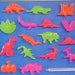 RARE Lite Bright 3D Character Accessory Pegs DINOSAURS Set Of 16