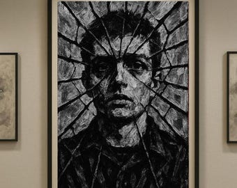 May include: Black and white portrait art print of a person's face, with a shattered glass effect overlay. The artwork is framed in a black frame and hangs on a neutral-colored wall. The art piece is a striking, modern piece.