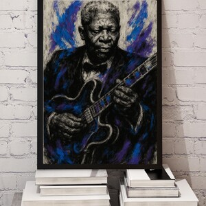 May include: A framed artwork featuring a portrait of a musician playing a guitar. The artwork is rendered in shades of black, blue, and purple, with a focus on the musician's face and hands. The guitar has a blue and purple design. The artwork is displayed against a white brick wall.
