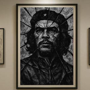 May include: A monochrome portrait print of a man in a black frame. The artwork is a detailed charcoal drawing, with a star on the hat. The image is framed in a black frame.