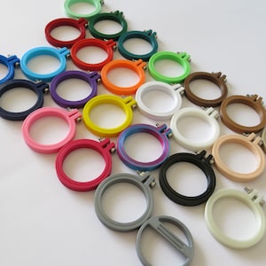 May include: A set of 18 colourful embroidery hoops, ranging in size from small to large. The hoops are made of plastic and have a smooth finish. They are perfect for crafting and embroidery projects.