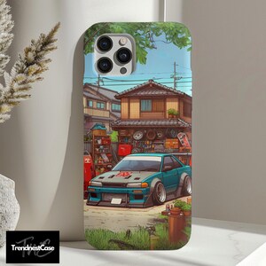 May include: A blue and white car with a red number '567' on the hood is parked in front of a garage. The garage has a wooden door and a window. The car is surrounded by green grass and trees. The background is a blue sky with white clouds.