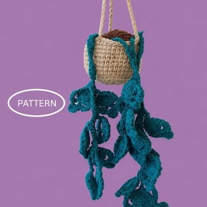 May include: A crocheted hanging plant in a beige pot with brown soil, featuring long, trailing teal vines with rounded leaves. The item includes a beige cord for suspension and a white oval graphic containing the text PATTERN.