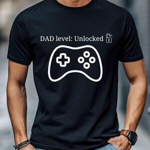 Dad Level: Unlocked – Funny New Dad T-Shirt | Unisex Heavy Cotton Tee