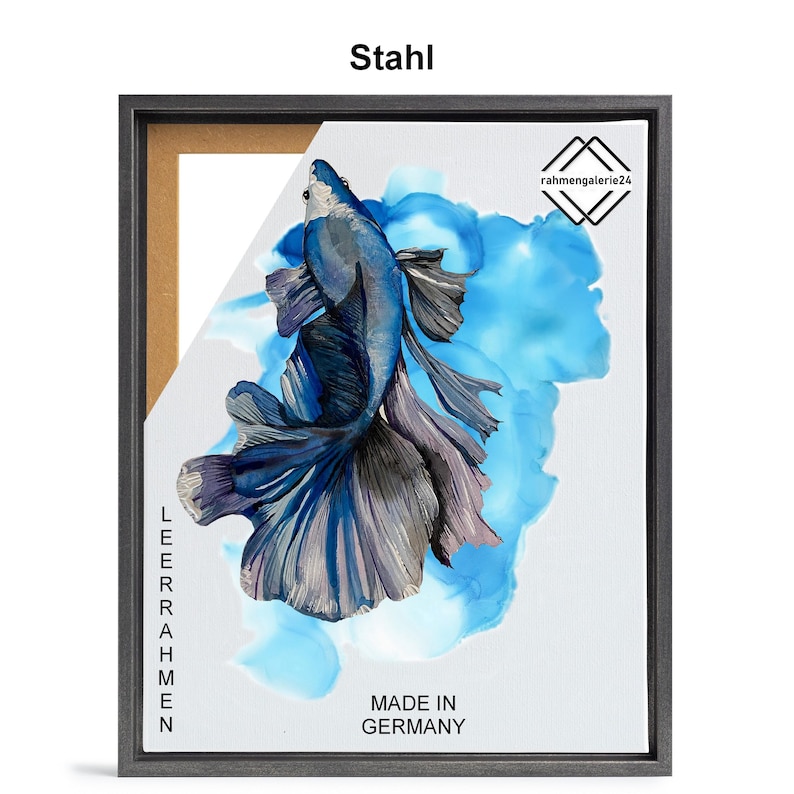May include: A framed print of a blue betta fish with a long, flowing tail, swimming in a blue and white watercolor background. The frame is made of wood and has a black finish. The print is titled "Stahl" and includes the text "Made in Germany".