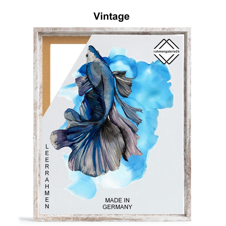 May include: A framed print of a blue and silver betta fish with a blue and white watercolor background. The print is titled "Vintage" and has the text "Made in Germany" at the bottom. The frame is a light wood color.