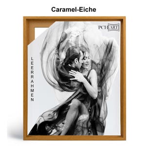 May include: A black and white photograph of a couple dancing the tango. The couple is framed in a wooden frame with the text "LEERAHMEN" and "PCH ART" visible. The frame is labeled "Caramel-Eiche".